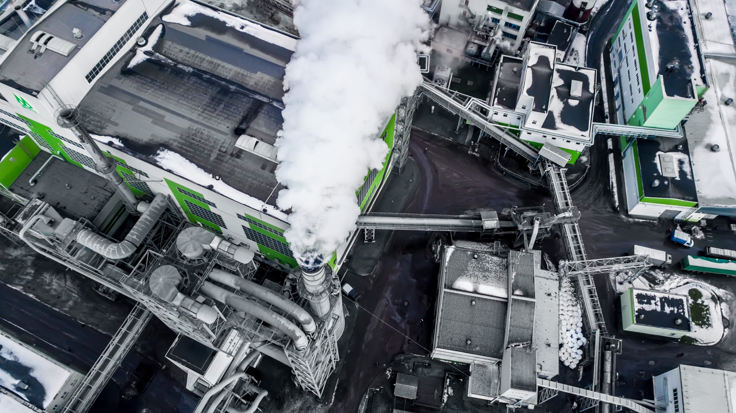 pipes of woodworking enterprise plant sawmill in the morning dawn. Air pollution concept. Industrial landscape environmental pollution waste of thermal power plant
